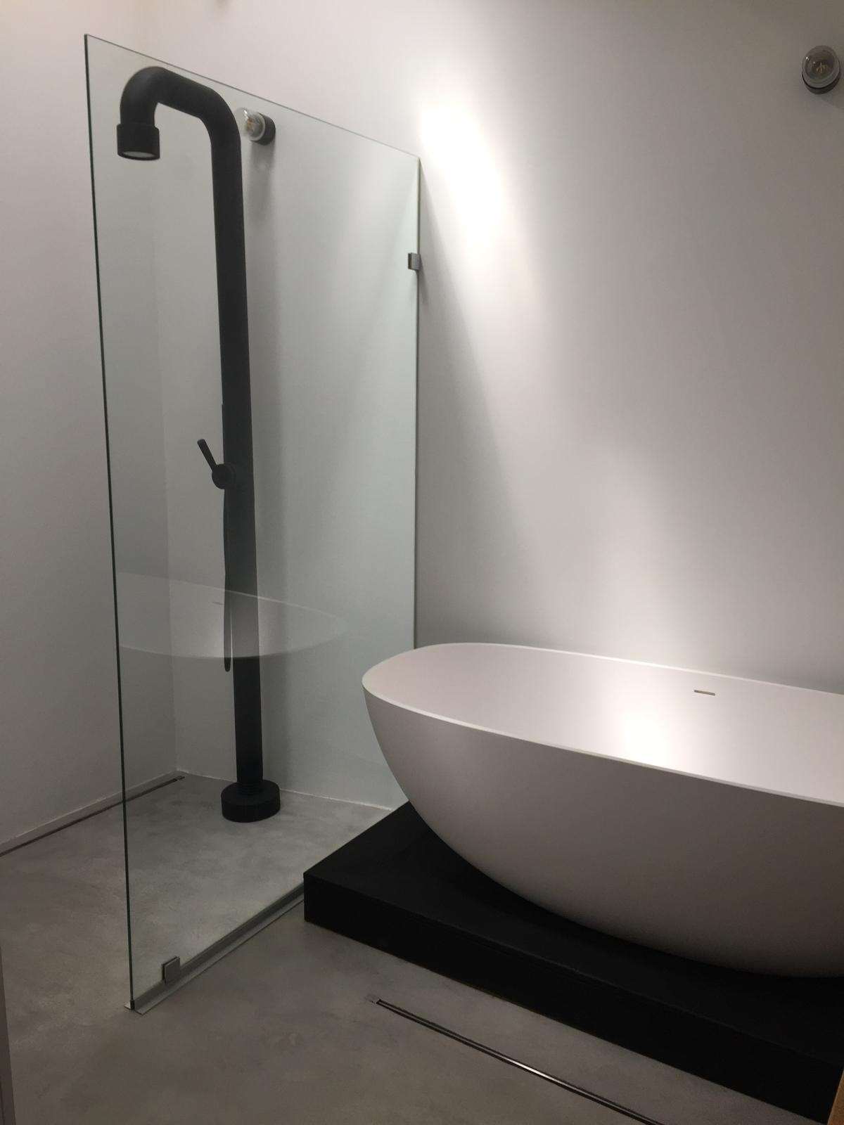 Continuous microcement bathroom in a warm neutral colour